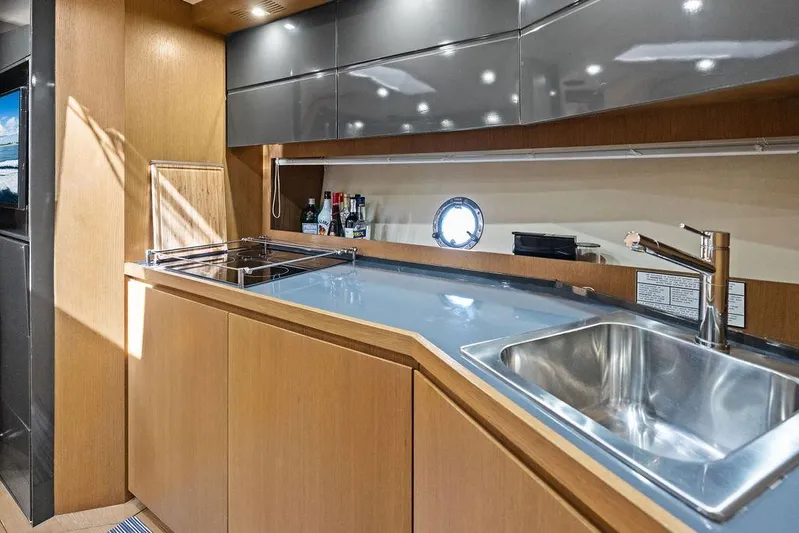  Yacht Photos Pics Modern kitchen interior of 2013 Azimut Atlantis 48 yacht with sleek cabinetry and stainless steel sink.