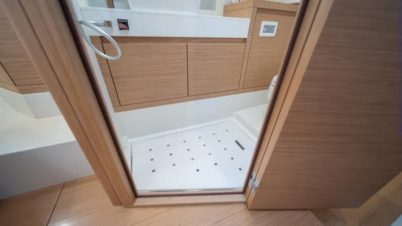 Freedom Yacht Photos Pics 2023 Pardo Yachts 38 bathroom interior with wooden cabinetry and shower area.
