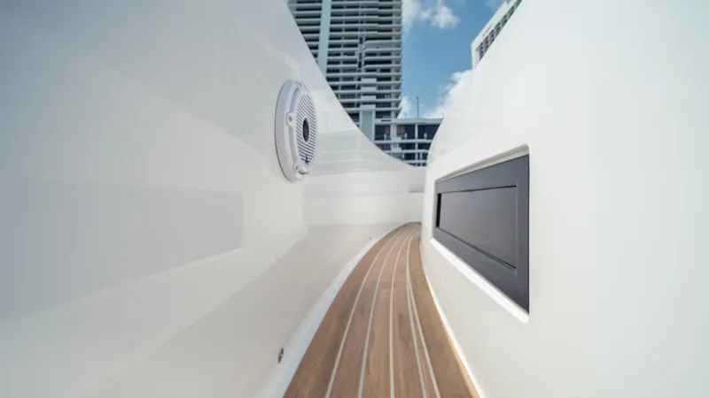 Freedom Yacht Photos Pics 2023 Pardo Yachts 38, sleek deck design with modern architecture in the background.