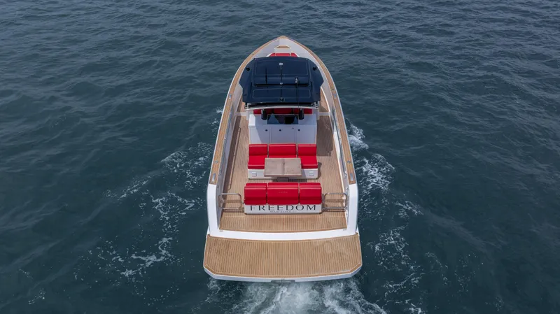 Freedom Yacht Photos Pics 2023 Pardo Yachts 38 cruising on open water, featuring sleek design and red seating.