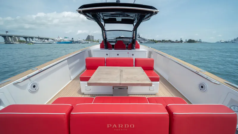 Freedom Yacht Photos Pics 2023 Pardo Yachts 38 with red seating and table on open deck, cruising on calm waters.