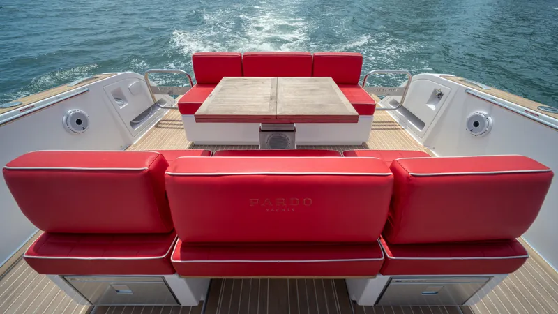 Freedom Yacht Photos Pics 2023 Pardo Yachts 38 with red seating and wooden deck, cruising on water.