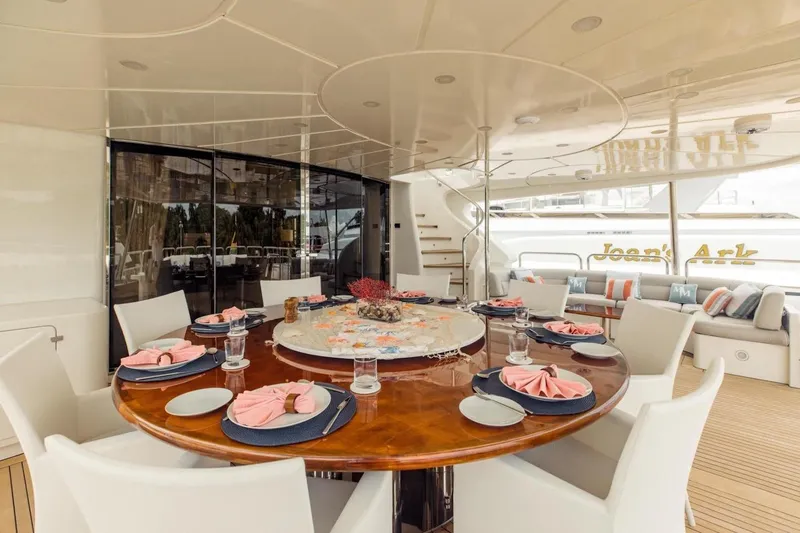 Mamma Mia Yacht Photos Pics Luxurious dining area on 2007 Benetti 120 Classic yacht, elegantly set table with pink napkins.