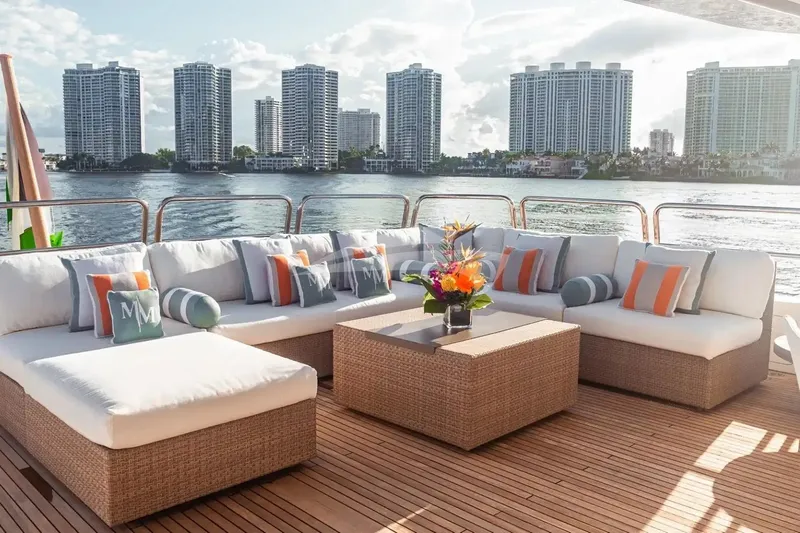 Mamma Mia Yacht Photos Pics Luxurious deck seating on 2007 Benetti 120 Classic yacht with waterfront cityscape view.