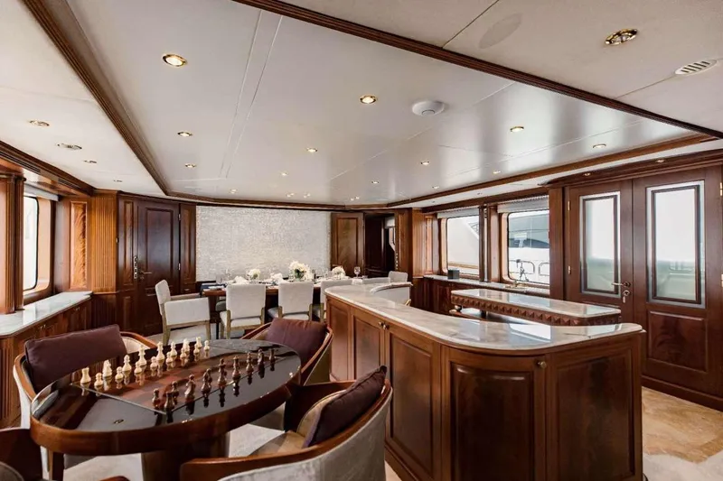 Mamma Mia Yacht Photos Pics Luxurious interior of 2007 Benetti 120 Classic yacht with elegant wood finishes and chess table.