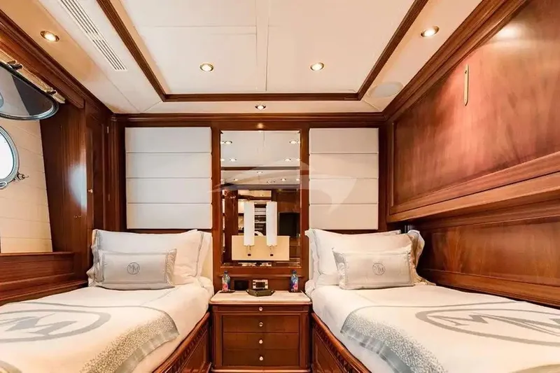 Mamma Mia Yacht Photos Pics Luxurious twin cabin interior on 2007 Benetti 120 Classic yacht, featuring elegant wood paneling.