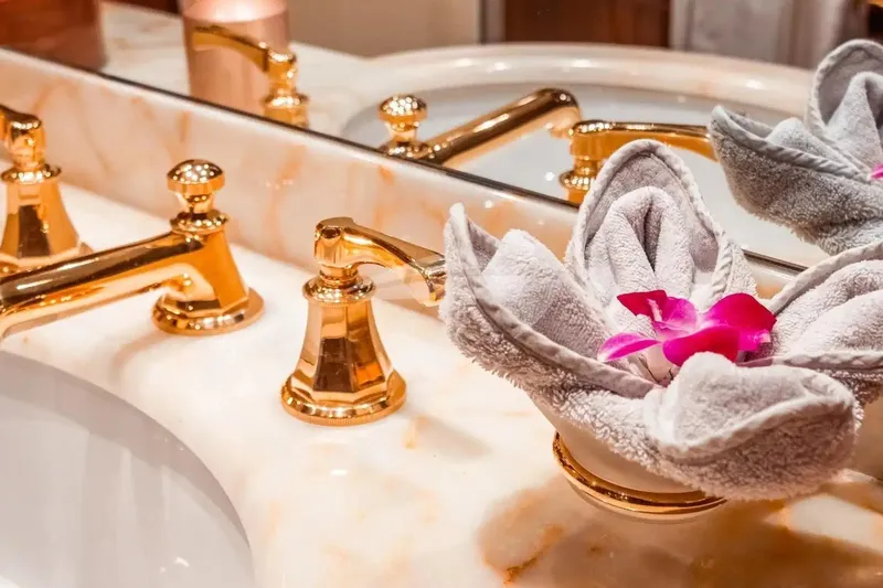 Mamma Mia Yacht Photos Pics Luxurious bathroom sink with gold fixtures and decorative towel on Benetti 120 Classic yacht.