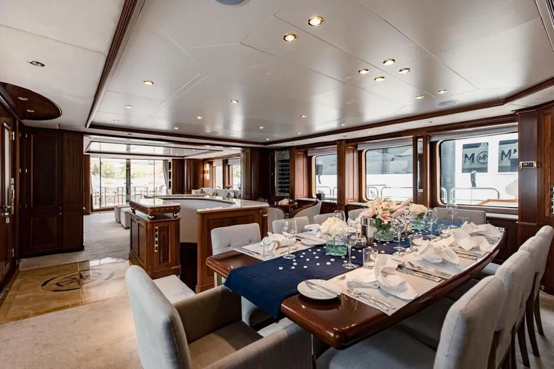 Mamma Mia Yacht Photos Pics Luxurious dining area on a 2007 Benetti 120 Classic yacht, featuring elegant table settings.