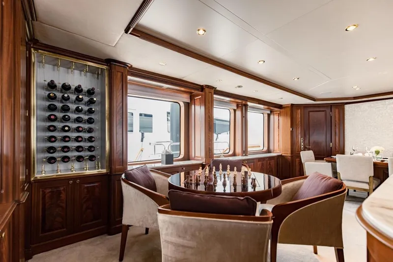 Mamma Mia Yacht Photos Pics Luxurious interior of 2007 Benetti 120 Classic yacht with wine rack and chess table.