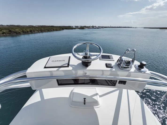 Blondie Yacht Photos Pics Helm of 2012 Viking 42 Open yacht with Garmin navigation, cruising on calm waters.