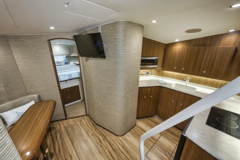 Blondie Yacht Photos Pics Luxurious interior of 2012 Viking 42 Open yacht with modern kitchen and cozy seating area.