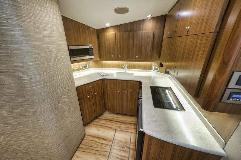 Blondie Yacht Photos Pics Luxurious kitchen interior of 2012 Viking 42 Open yacht with modern wood cabinetry.