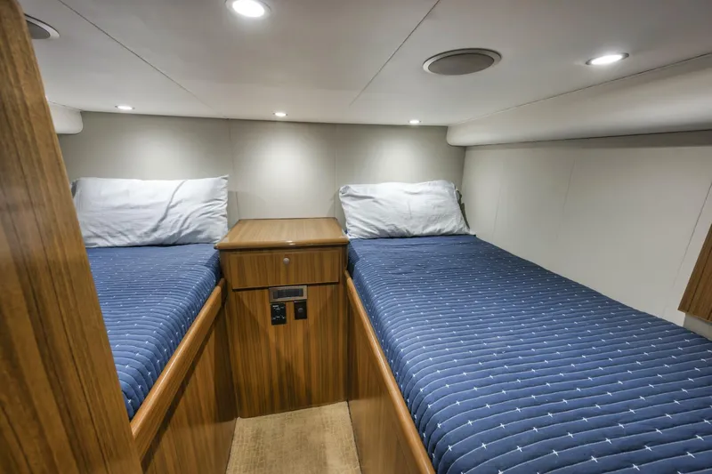 Blondie Yacht Photos Pics 2012 Viking 42 Open cabin with twin beds, wooden cabinetry, and modern lighting.