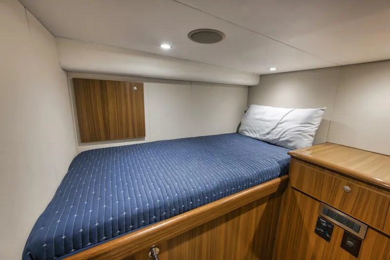 Blondie Yacht Photos Pics Cozy cabin bed in 2012 Viking 42 Open yacht with wood accents and blue bedding.