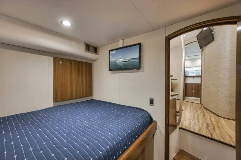 Blondie Yacht Photos Pics 2012 Viking 42 Open yacht cabin with bed, TV, and wooden accents.