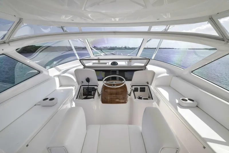 Blondie Yacht Photos Pics Luxurious interior of 2012 Viking 42 Open yacht with panoramic windows and sleek white seating.