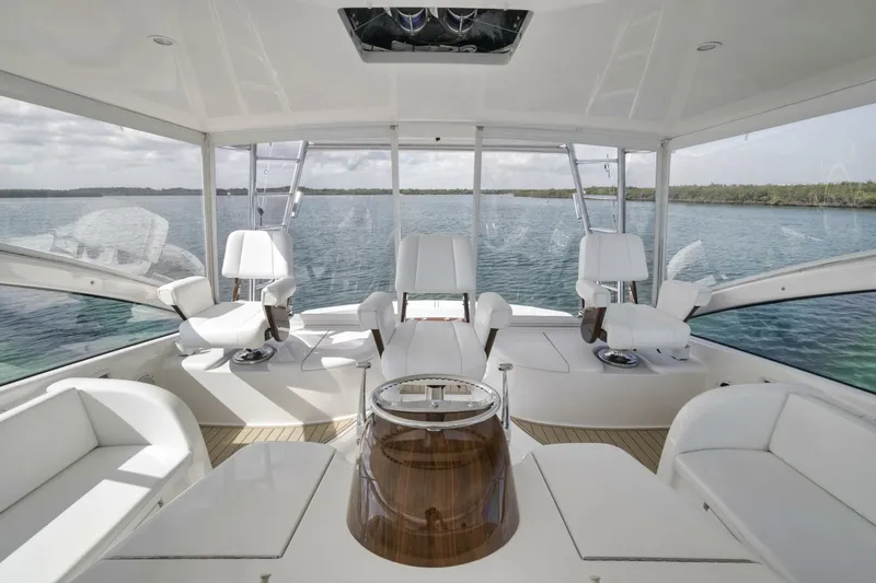 Blondie Yacht Photos Pics Luxurious interior of 2012 Viking 42 Open yacht with white seating and panoramic views.