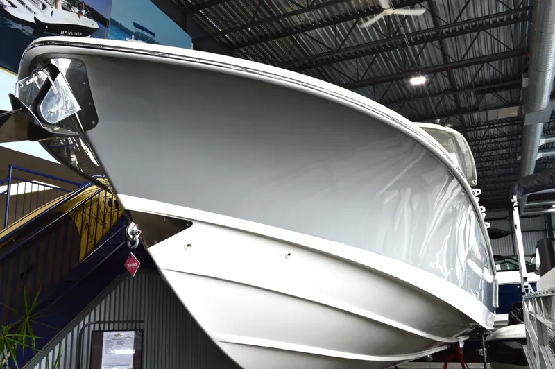  Yacht Photos Pics 2024 Boston Whaler 350 Realm boat displayed indoors, showcasing sleek design and modern features.