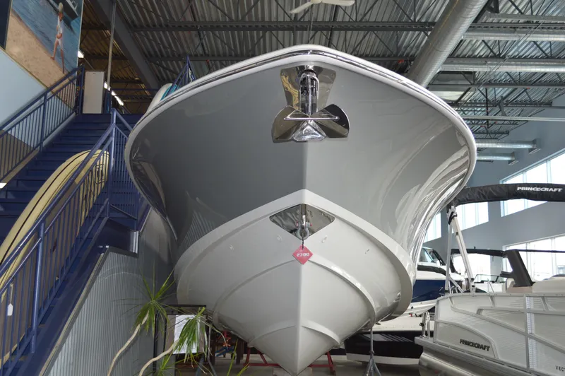  Yacht Photos Pics 2024 Boston Whaler 350 Realm boat displayed indoors, showcasing sleek design and modern features.