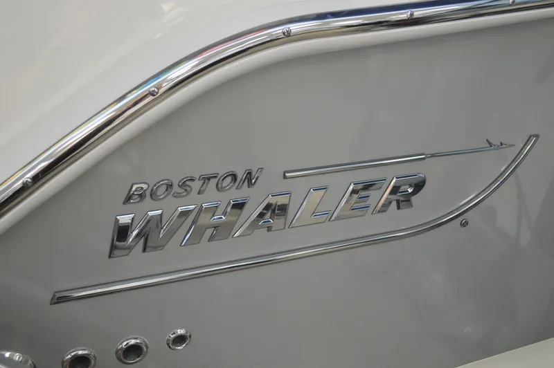  Yacht Photos Pics 2024 Boston Whaler 350 Realm logo on boat hull with chrome detailing.