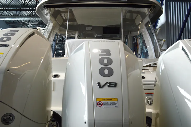  Yacht Photos Pics 2024 Boston Whaler 350 Realm with triple Mercury 300 V8 engines in a showroom.