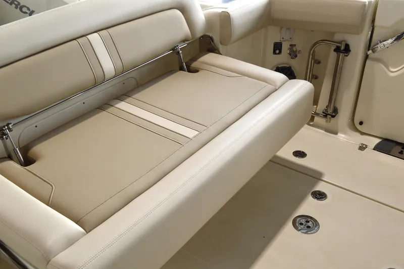  Yacht Photos Pics 2024 Boston Whaler 350 Realm boat interior with beige seating and stainless steel accents.