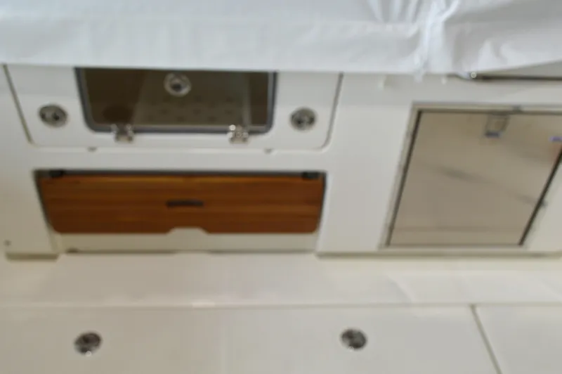  Yacht Photos Pics 2024 Boston Whaler 350 Realm interior with storage compartments and sleek design.