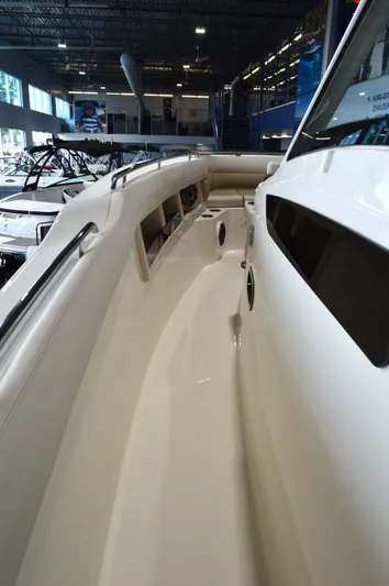  Yacht Photos Pics 2024 Boston Whaler 350 Realm boat interior, showcasing sleek design and spacious walkway.