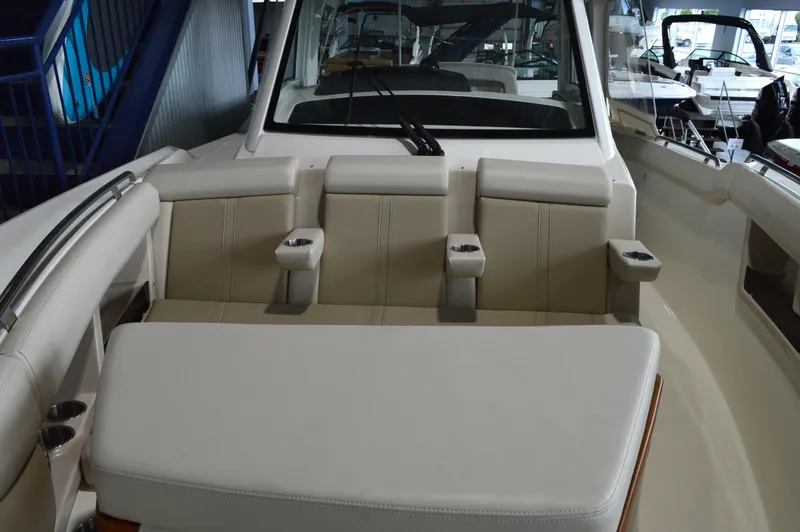  Yacht Photos Pics 2024 Boston Whaler 350 Realm boat interior with beige seating and cup holders.