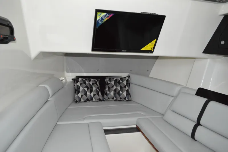  Yacht Photos Pics 2024 Boston Whaler 350 Realm interior with gray seating and wall-mounted TV.