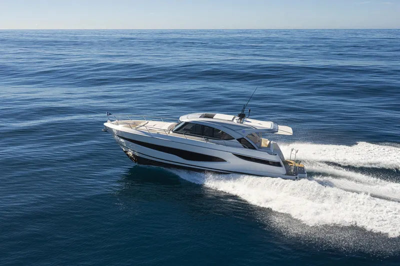  Yacht Photos Pics 2025 Riviera 4300 yacht cruising on open ocean waters.