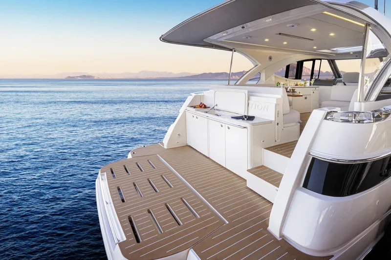  Yacht Photos Pics Luxurious 2025 Riviera 4300 yacht with spacious deck, overlooking serene ocean waters.