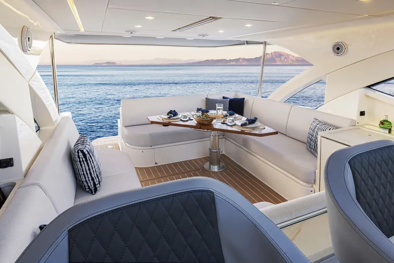  Yacht Photos Pics Luxurious 2025 Riviera 4300 yacht interior with elegant seating and ocean view.