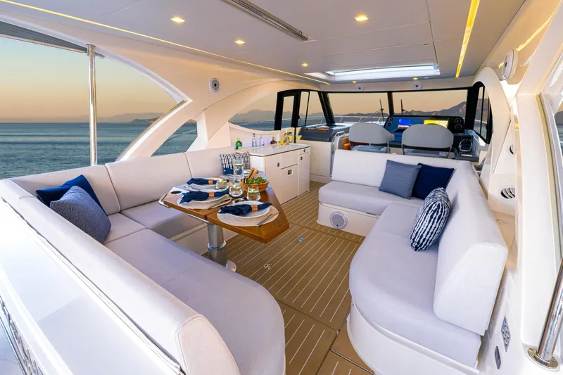  Yacht Photos Pics Luxurious interior of 2025 Riviera 4300 yacht with elegant seating and ocean view.