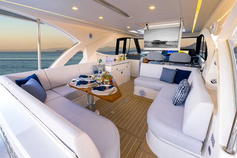  Yacht Photos Pics Luxurious interior of 2025 Riviera 4300 yacht with elegant seating and ocean view.