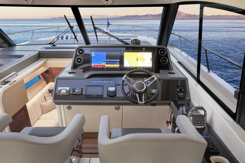  Yacht Photos Pics Interior of 2025 Riviera 4300 yacht cockpit with advanced navigation system and ocean view.