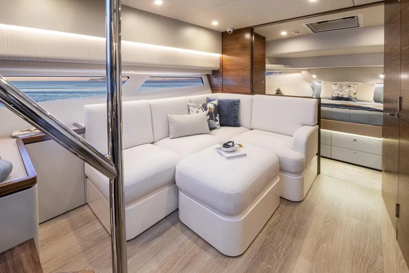  Yacht Photos Pics Luxurious interior of 2025 Riviera 4300 yacht with modern white seating and elegant decor.
