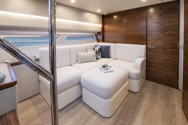  Yacht Photos Pics Luxurious interior of 2025 Riviera 4300 yacht with white seating and wooden accents.