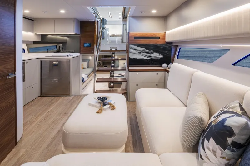  Yacht Photos Pics Luxurious interior of 2025 Riviera 4300 yacht with modern kitchen and elegant seating area.