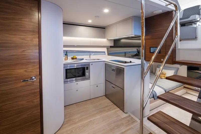 Yacht Photos Pics Modern kitchen interior of 2025 Riviera 4300 yacht with sleek design and wooden accents.