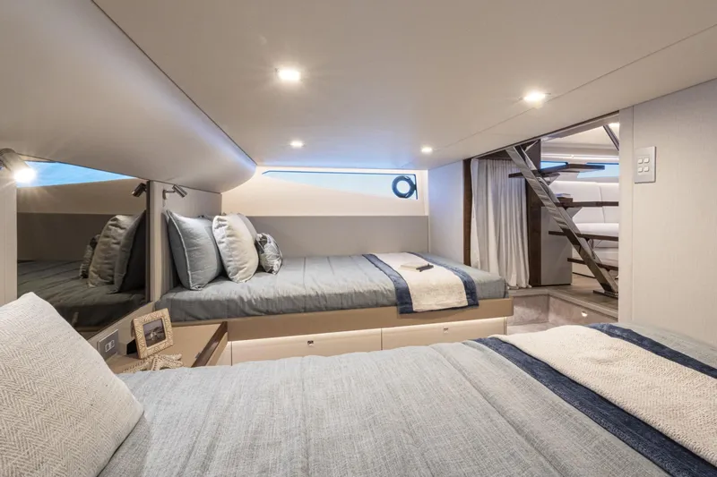  Yacht Photos Pics Luxurious 2025 Riviera 4300 yacht bedroom with modern design and cozy bedding.