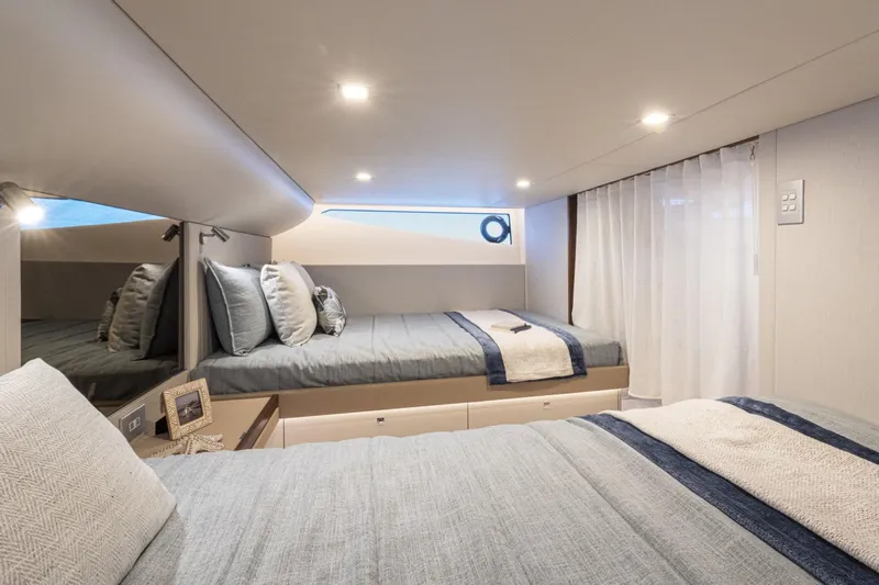  Yacht Photos Pics Luxurious 2025 Riviera 4300 yacht bedroom with modern design and cozy bedding.
