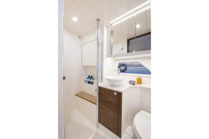  Yacht Photos Pics Luxurious bathroom in 2025 Riviera 4300 yacht with modern fixtures and ocean view.