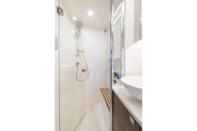  Yacht Photos Pics Modern bathroom in 2025 Riviera 4300 yacht with glass shower and sleek design.