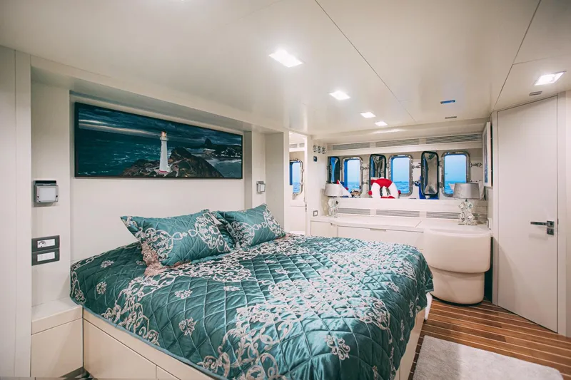 Yacht Photos Pics Luxurious bedroom interior of 2010 Benetti Sail Division 90 yacht with elegant bedding and ocean view.