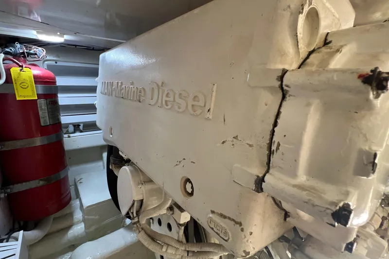 Dream On Yacht Photos Pics Engine room of 2005 Bertram 450 with MAN Marine Diesel engine and fire extinguisher.