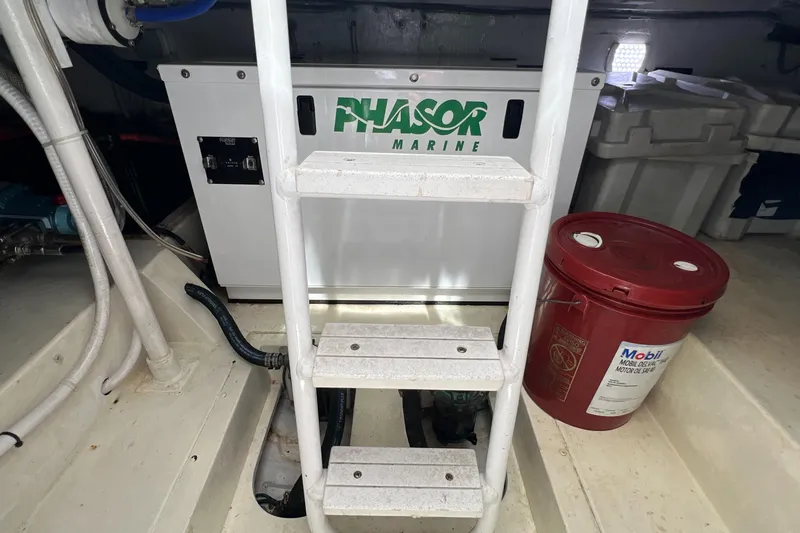 Dream On Yacht Photos Pics Engine room of 2005 Bertram 450 with Phasor Marine generator and Mobil oil container.