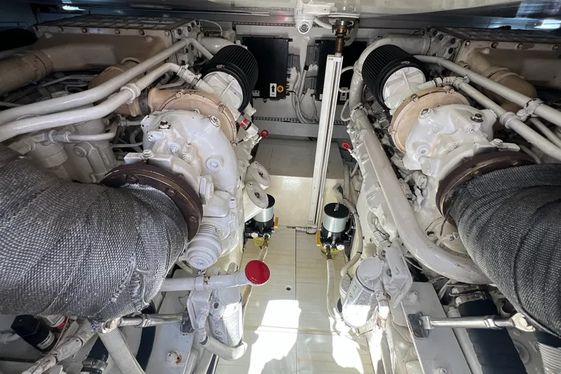 Dream On Yacht Photos Pics Engine room of a 2005 Bertram 450 yacht, showcasing dual engines and mechanical components.