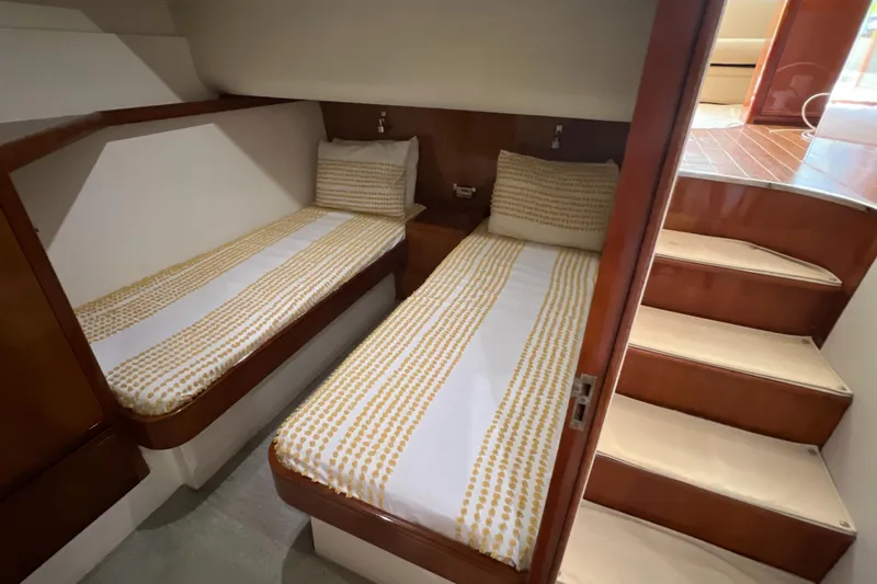 Dream On Yacht Photos Pics 2005 Bertram 450 yacht cabin with twin beds and wooden interior.