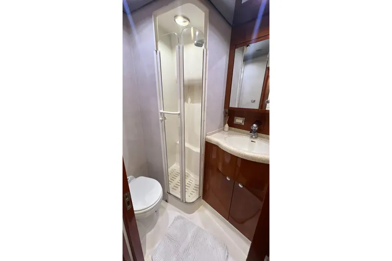 Dream On Yacht Photos Pics Luxurious bathroom in 2005 Bertram 450 yacht with shower, sink, and toilet.